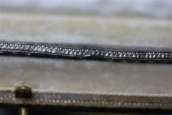 A 1920s 18ct white gold, sapphire and diamond set line bracelet, in original fitted Charles Packer & Co Ltd box.